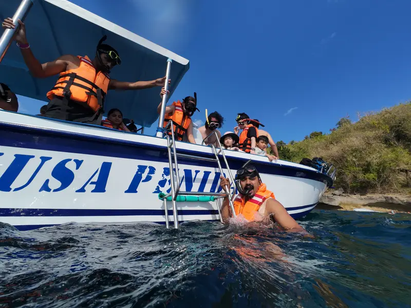 Guests wearing life jackets boarding the boat at Nusa Penida