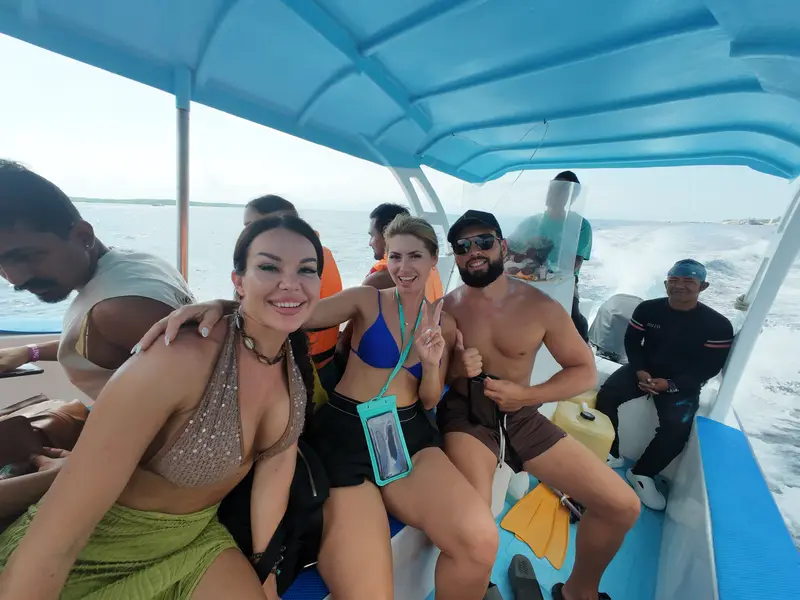Group of guests smiling on the shared snorkeling boat
