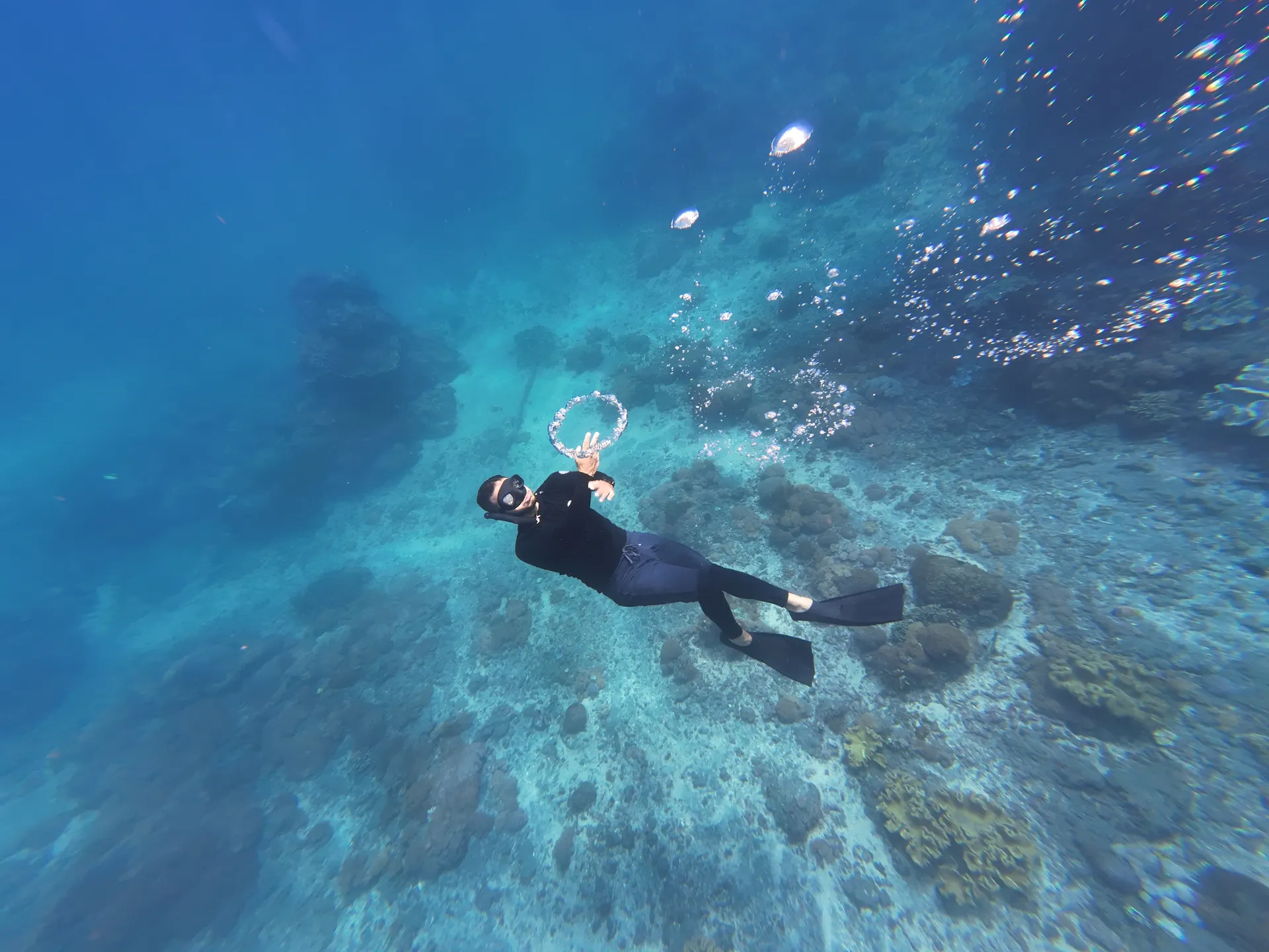 Snorkeler over the coral garden at Crystal Bay, Nusa Penida